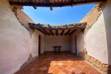 Abandoned Room with Missing Ceiling and Open Sky