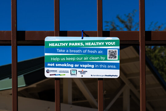 Chandler, AZ - Nov. 24, 2025: Healthy Parks, Healthy You signage at Desert Breeze Park indicating a clean air zone with no smoking or vaping allowed.