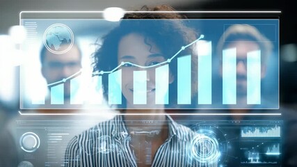 Confident young businesswoman smiling at futuristic digital interface, surrounded by colleagues in a modern office. Innovative technology and teamwork drive workplace success - Powered by Adobe