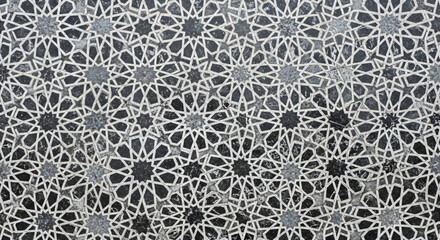 Intricate Islamic geometric star patterns on grey stone surface