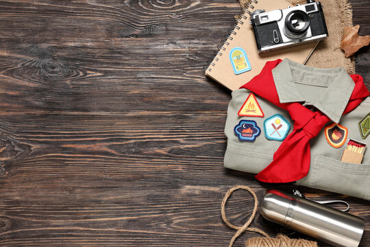Scout's accessories on wooden background