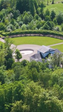 ch&acirc;teau seneffe surrounded by green trees overlooking fields nearby water bodies add scenic landscape to left right pans aerial of de belgium 