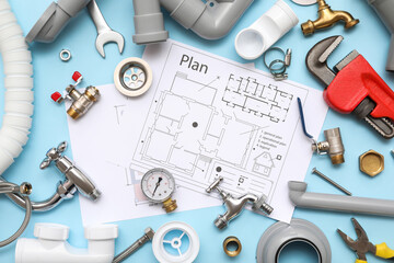 Composition with plumber's items and house plans on blue background