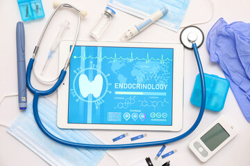 Tablet computer with open endocrinology app and medical supplies on white background