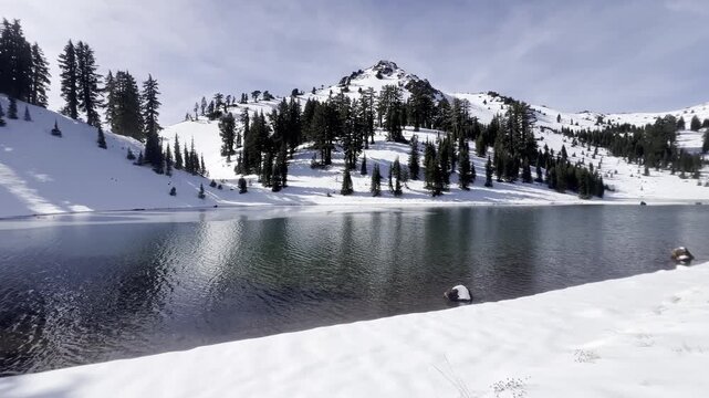 Snow covered landscape surrounding the Ridge Lake with icy volcanic peaks at Lassen Volcanic National Park