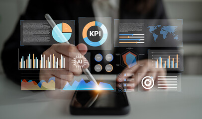 A business professional uses a smartphone to analyze interactive graphs and charts, highlighting technology and innovation in digital data analysis for effective decision-making. Gantry
