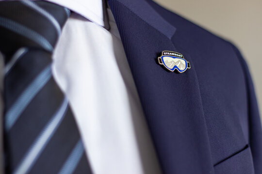 Steamboat ski goggles lapel pin on suit jacket
