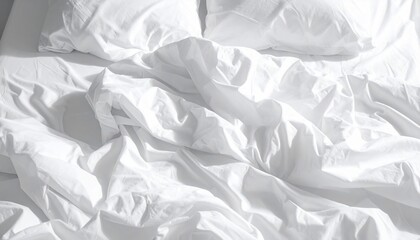 Obraz premium Close-up of unmade bed with crumpled white sheets and pillows, lit by soft light