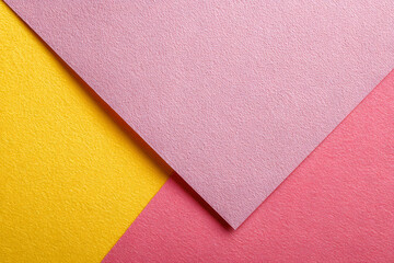 a close up of a pink and yellow paper