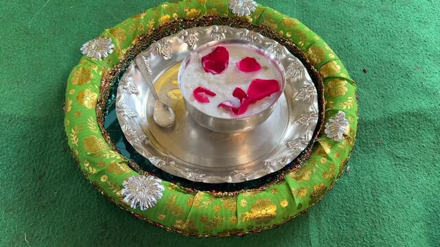 Close up shot of kheer prepared with milk served in silver utensil for rice ceremony in Kolkata, India