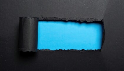 Ripped black paper texture with rolled edge revealing blue background with copy space. Abstract concept