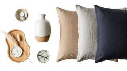 Top down flat lay of curated Japandi decor items including a ceramic vase and linen cushions isolated on white background