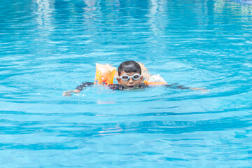 Boy wearing a life jacket in the pool