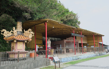 The Wanshan Gong (萬善公) shrine, a small, traditional temple commemorating the deceased, located along the coastal walking path, Heping Island Park, Keelung, Taiwan.