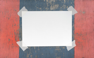 Blank Paper Sheet with Adhesive Tape on Wooden Background. File with Clipping Path.