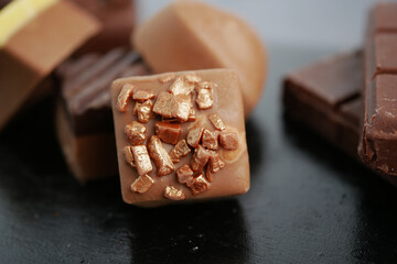 Chocolate with gold pieces on a black surface