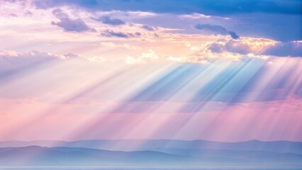 Sunbeams piercing through clouds over serene mountain landscape