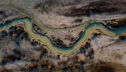 Aerial View of Winding River Through Autumn Landscape.