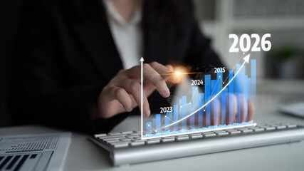 Businessperson engaged in data analysis examines a digital growth chart with future projections, emphasizing strategic planning and financial success in a professional setting. Tessel
