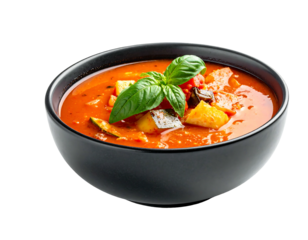 A close-up shot of a dark bowl filled with vibrant, chunky tomato soup, garnished with a fresh basil sprig