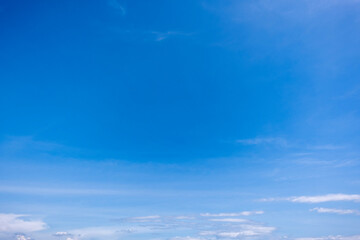 Obraz premium clear blue sky background,clouds with background, Blue sky background with tiny clouds. White fluffy clouds in the blue sky. 