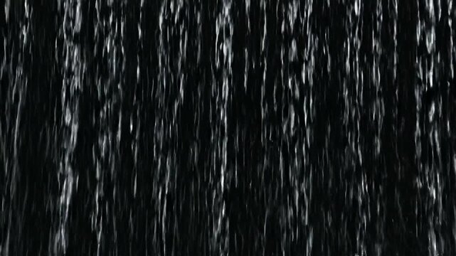 Image shows a vertical pattern of water streaks against a black background