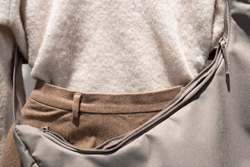 Minimalist autumn fashion set with wool sweater brown trousers and crossbody bag. autumn and winter fashion concepts, lifestyle blog content, and modern apparel marketing.