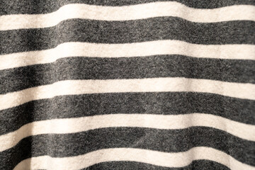 Black and white striped fabric texture background close up of knitted material. Background for fashion, textile industries, minimalist design with a cozy and modern feel.