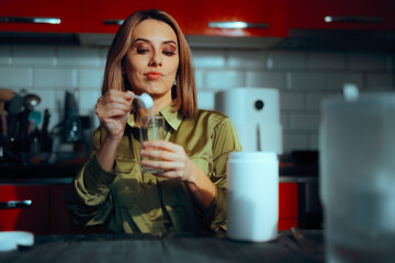 Careful Woman Preparing a Collagen Powder Supplement. Lady making her anti age drink for skin care, nails and joints