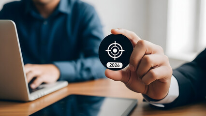 A person holding a black smart card with a white target logo