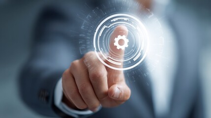 Close-up of a person's hand touching a glowing virtual gear icon. The background features a blurred business suit in soft focus