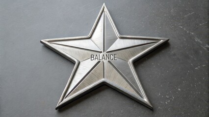 Obraz premium A precisely symmetrical six-pointed star made of polished metal, displaying the word 'BALANCE' on its surface.