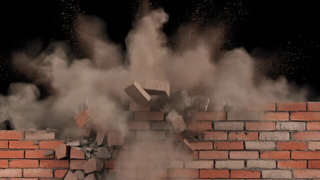 Brick Wall Exploding Outwards with Demolition Dust and Rubble Isolated on Black