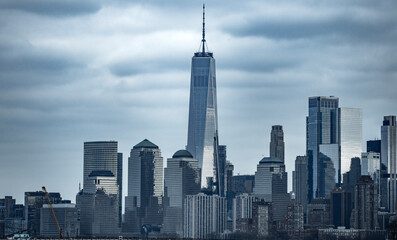 New York City skyline wide banner. Manhattan skyline with glass towers. NYC skyline landscape. New York panorama city. Manhattan skyline glowing at dusk. NYC with downtown towers.