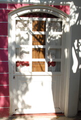 Artisanal process of covering door windows with natural bamboo sticks using basic hand tools and safety gloves