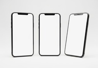 Three modern smartphones with blank screens isolated on light cream background