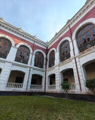 Weathered Facade of an Old Building with Broken Arched Windows