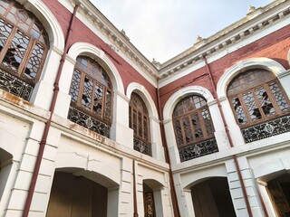 Weathered Facade of an Old Building with Broken Arched Windows