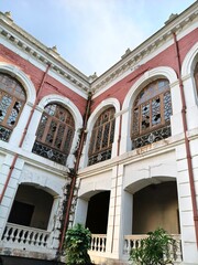 Weathered Facade of an Old Building with Broken Arched Windows