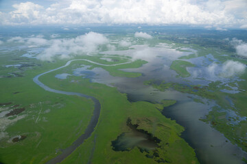 A Colombian Air Force HH-60 flies over landscape 