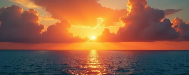 Golden sunrise paints vibrant orange clouds above a calm ocean , scenic, peaceful, glow