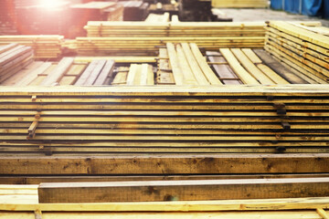 Stack of fresh pine boards in a sawmill warehouse. Harvesting, sale of lumber for construction