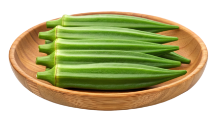 Okra pods with prominent ridges arranged in a wooden bowl on a white background