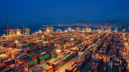 Aerial view of a bustling shipping port at dusk with numerous colorful containers and cranes - Powered by Adobe