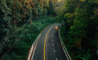 Aerial view of roads and forest in the evening; environmentally friendly travel and transportation.