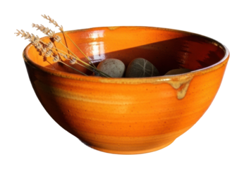 Rustic orange bowl with stones and dried flowers home still life isolated on transparent background