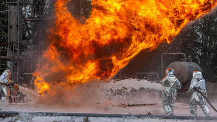 Firefighters use a foam generator to supply foam to extinguish the fire. A fire at the plant caused by the ignition of an oil product. Firefighters extinguish a fire at an oil refinery.