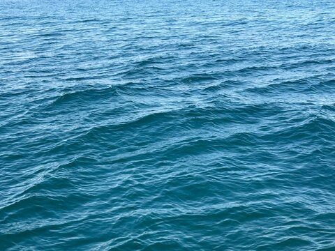 Blue sea water surface background.