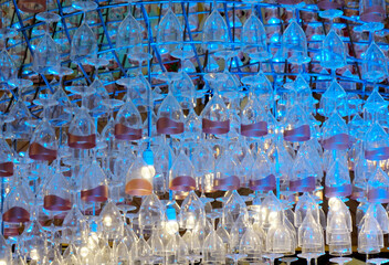 Ceiling decoration, Wine glass hang with structure and blue color lighting decorate ceiling at mall
