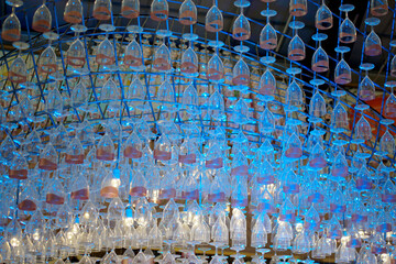 Ceiling decoration, Wine glass hang with structure and blue color lighting decorate ceiling at mall